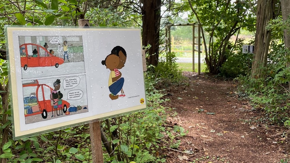 StoryWalk book photo on the trail